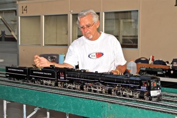 A man (who is not my Dad) inspecting a model train